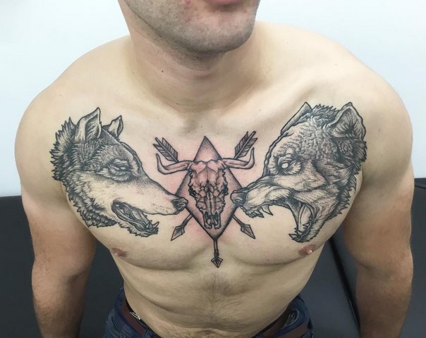 Мужская тату два волка и череп животного на груди